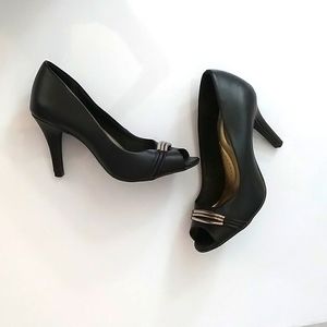 Black, open toe heels with goldtone detail.